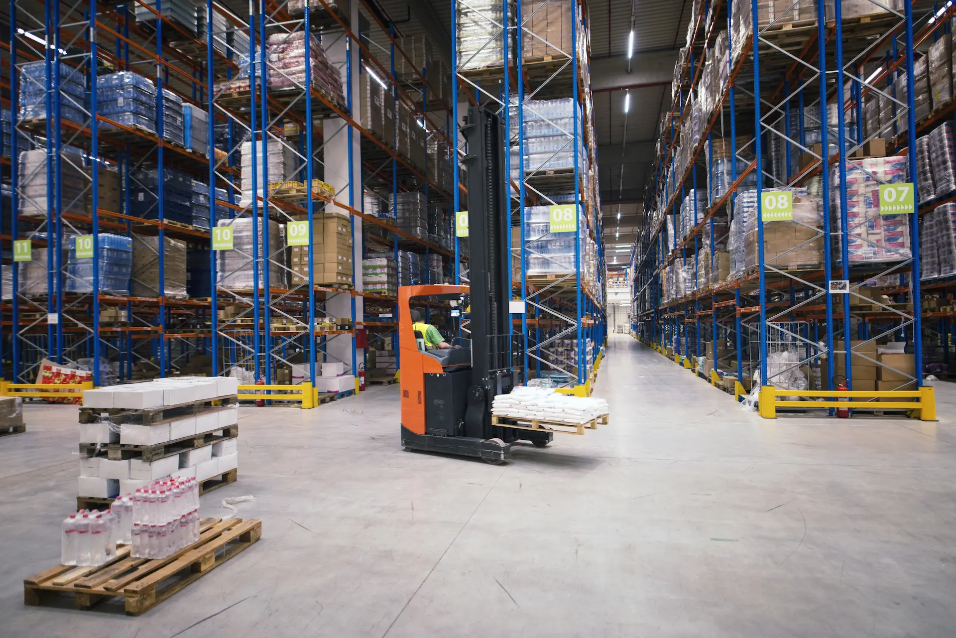 Forklift working in logistics warehouse